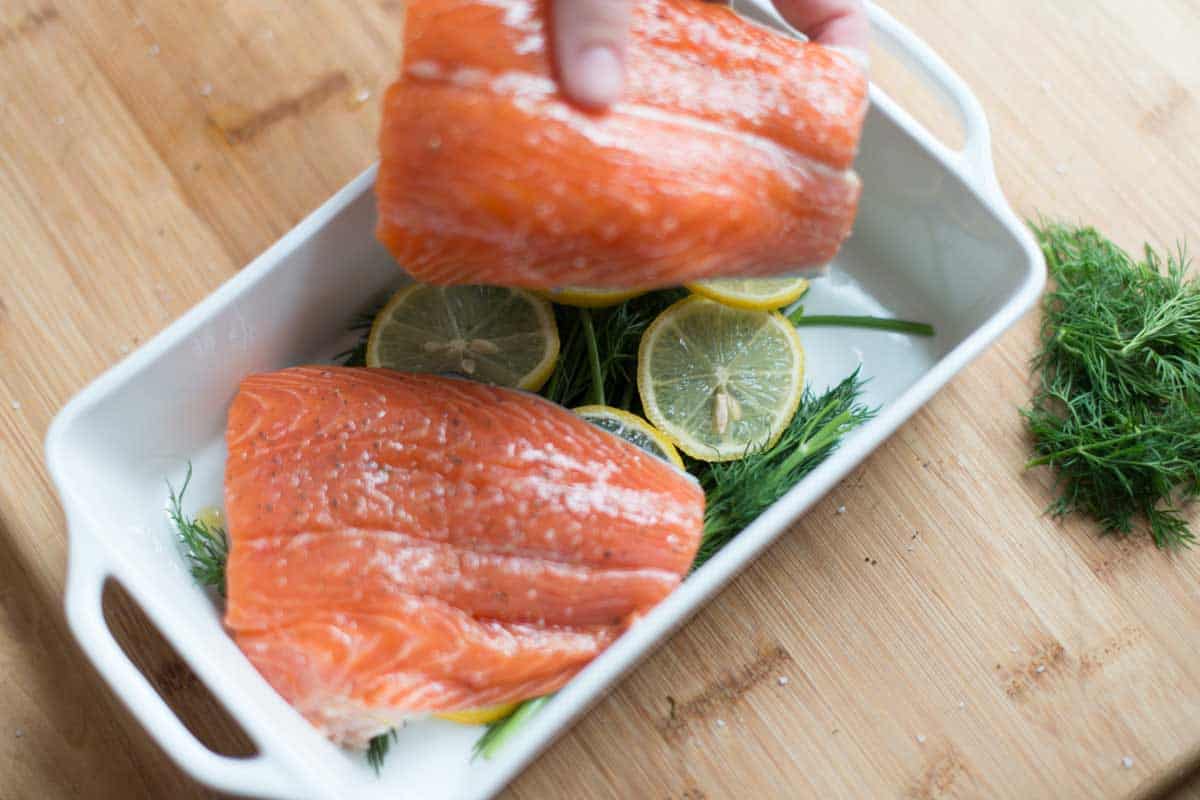 Baking salmon on top of lemon slices, fresh dill, and add a little liquid (like wine, water, or broth).