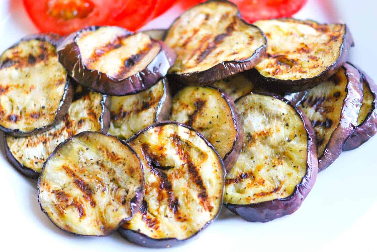 Stacked Grilled Eggplant and Tomato Salad Grilled Eggplant ready to be stacked with tomatoes and mozzarella for vegetable Napoleon