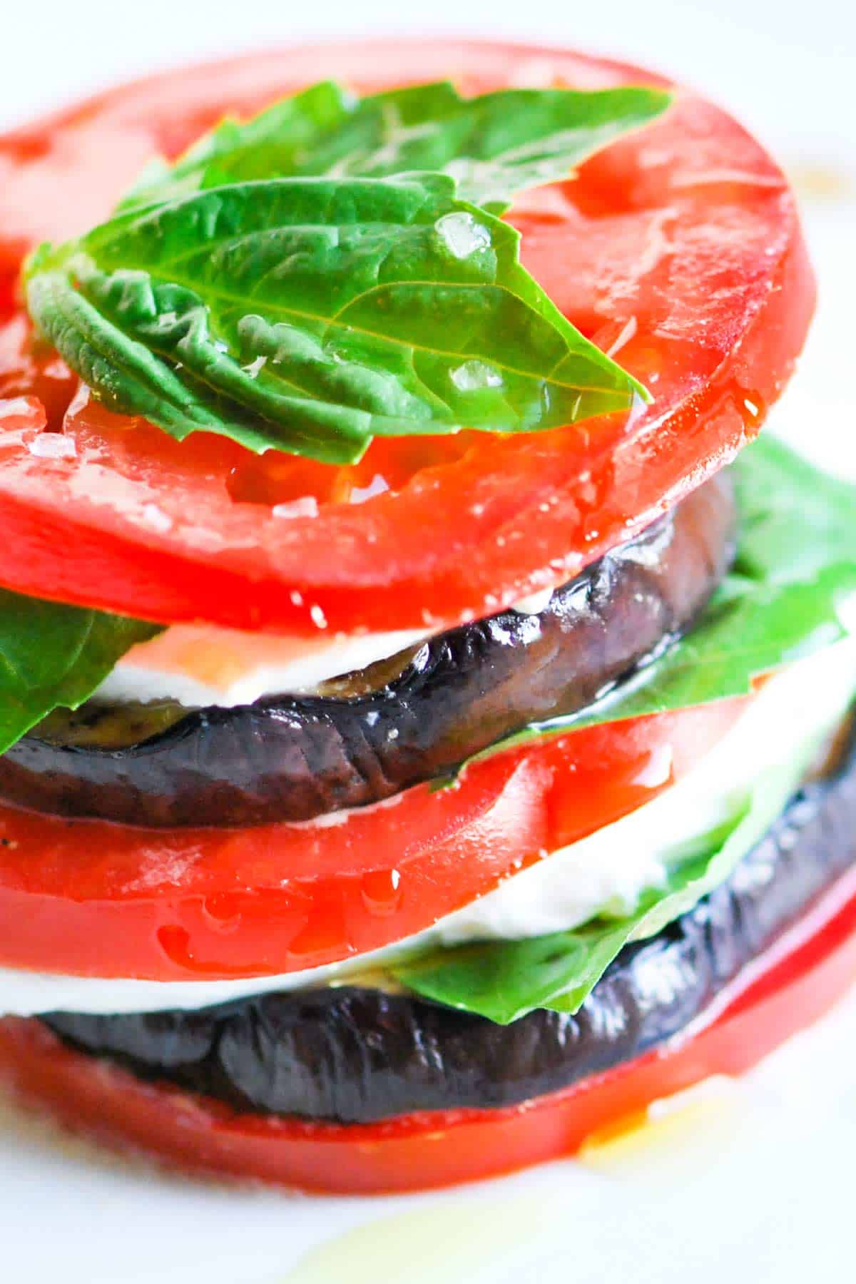 Stacked Grilled Eggplant and Tomato Salad Eggplant Napoleon: Stacked grilled eggplant, tomato slices, basil, and mozzarella create a light vegetarian meal.