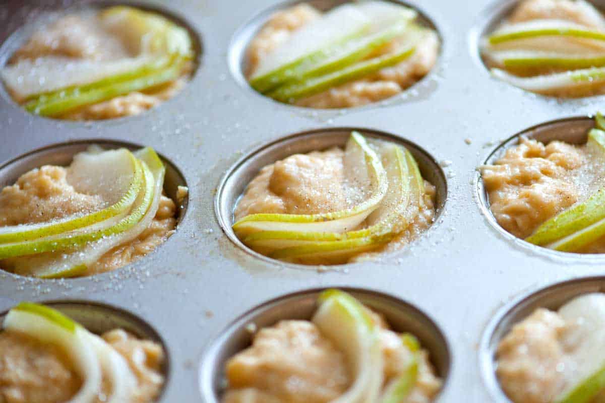 Pear and Vanilla Muffins Recipe Vanilla muffin batter with fresh pear slices pressed on top