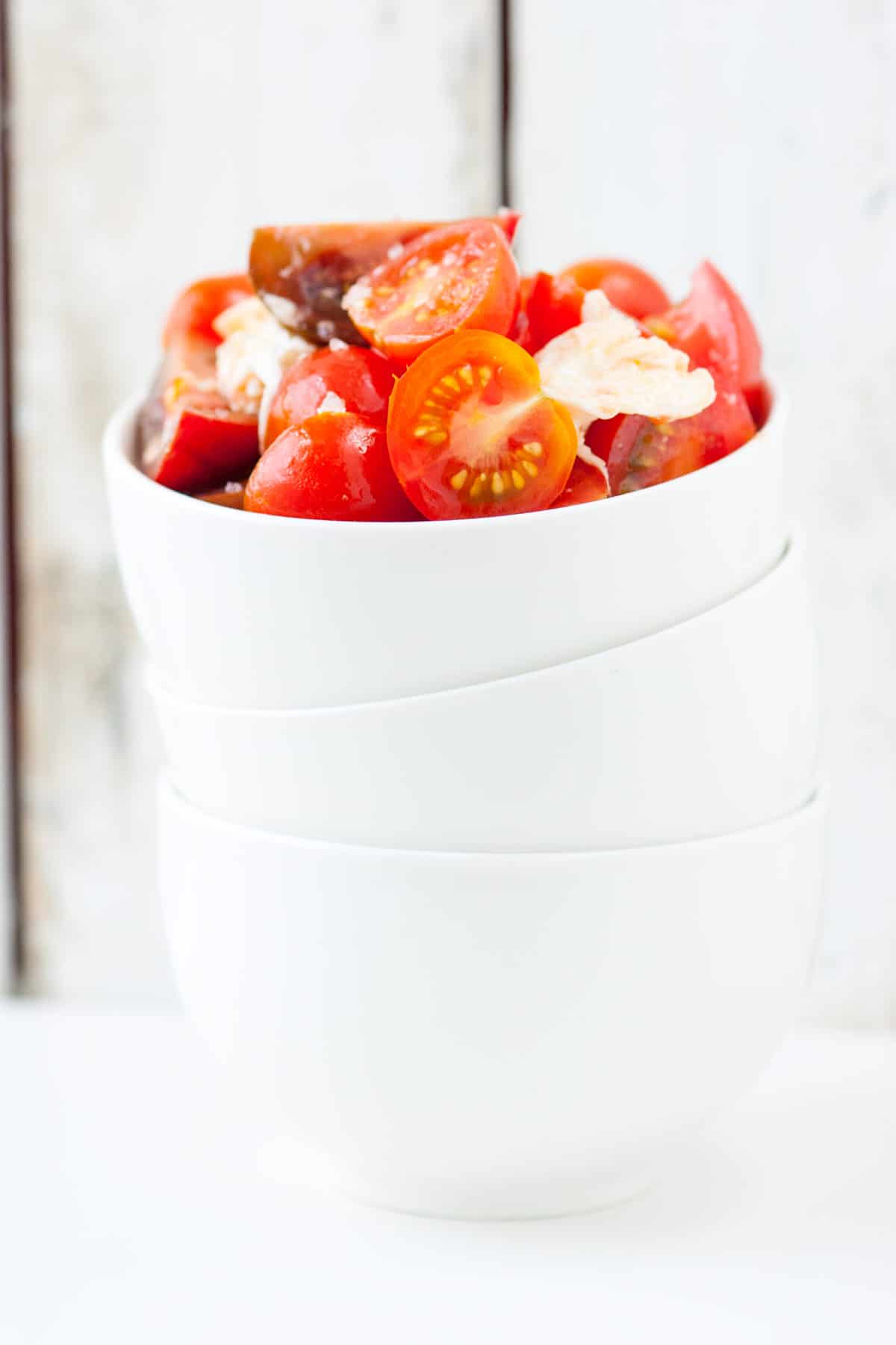 Our favorite tomato salad recipe! Simply seasoned tomatoes, fresh mozzarella cheese and a little olive oil. It really doesn't get much simpler than this.