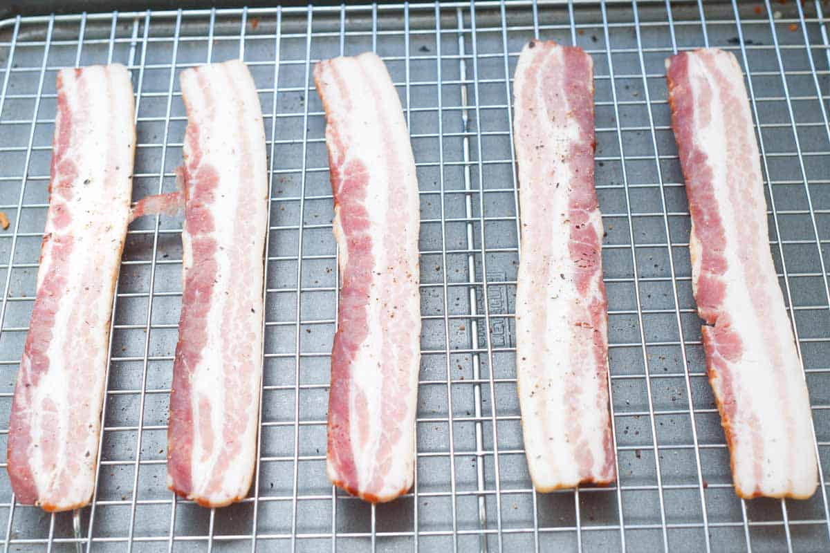 How to Bake Bacon in the Oven (photo showing baking bacon on rack)