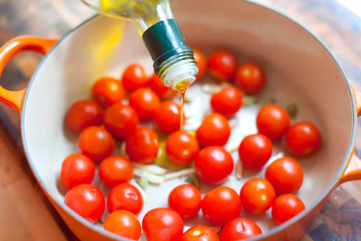 Add the tomatoes and olive oil