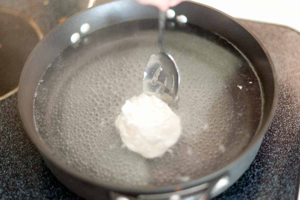 How to Easily Poach an Egg Perfectly Every Time Use a spoon to push the whites over the yolk for perfect poached eggs