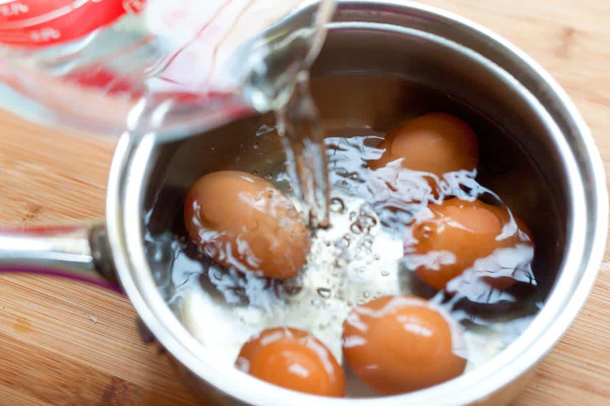 How to Cook Hard Boiled Eggs -- Cover the eggs with about two inches of room temperature or cold water.
