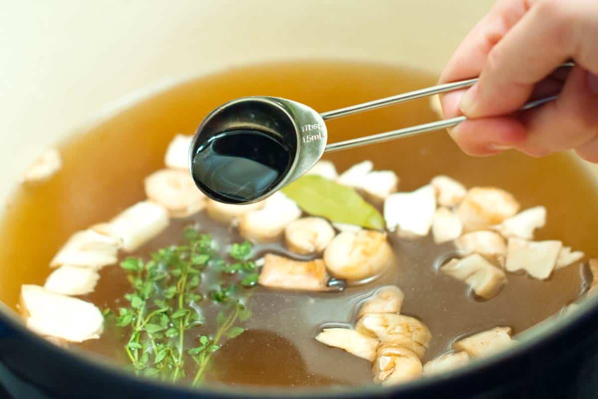 Seasoning the risotto stock with soy sauce