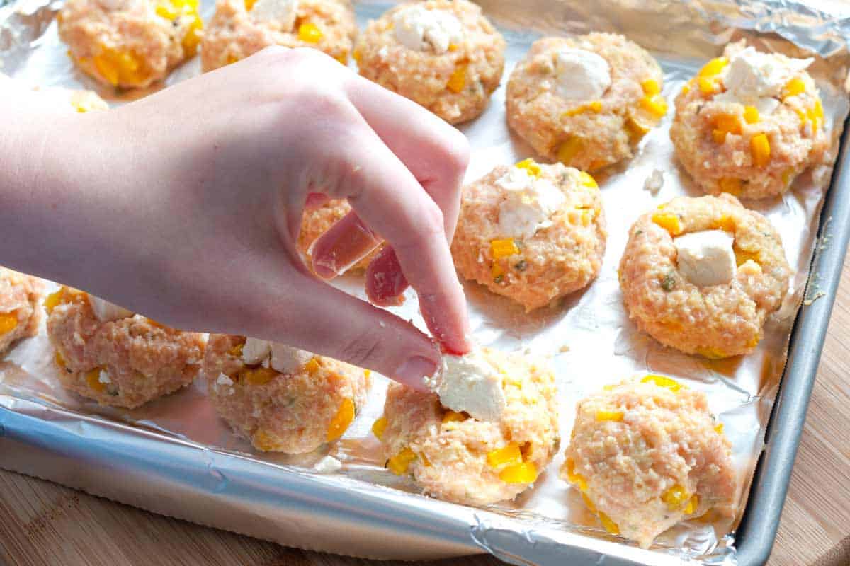 Adding cheese to the middle of unbaked chicken meatballs