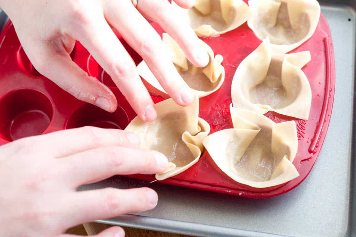 How to Bake Wonton Cups How to Make Wonton Cups: Pushing wontons into a mini cupcake pan.