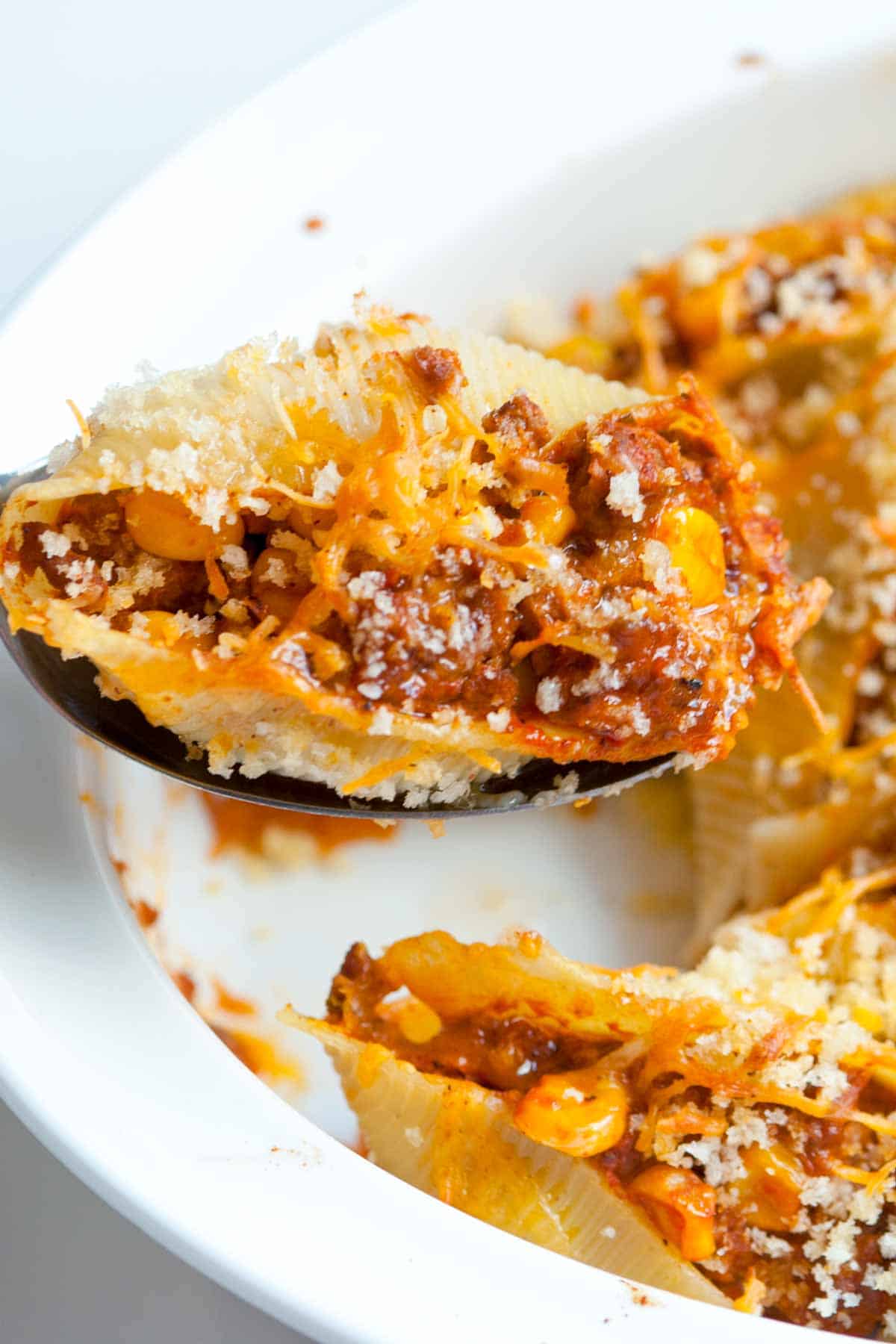 Taco inspired pasta shells filled with spiced ground beef, cheese and corn.