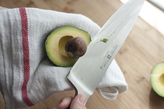 Removing an avocado seed with a knife