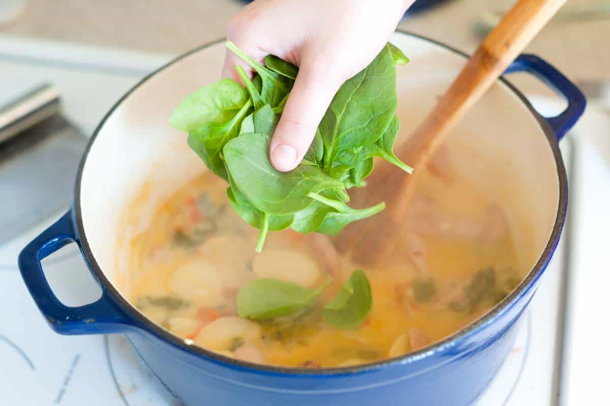 How to Make Chicken Sausage Soup: Adding the spinach.