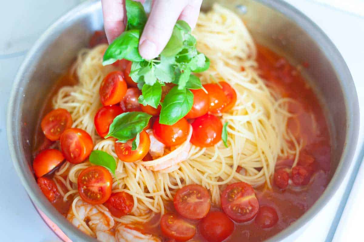 Finishing the tomato basil sauce