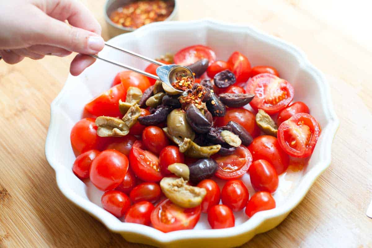 Adding the tomatoes to the baking dish