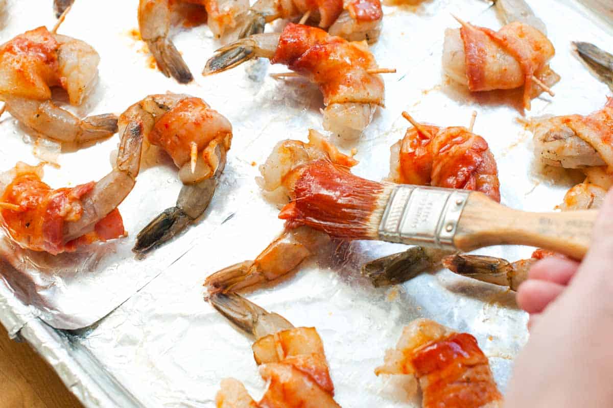 Adding the spicy maple glaze to the shrimp