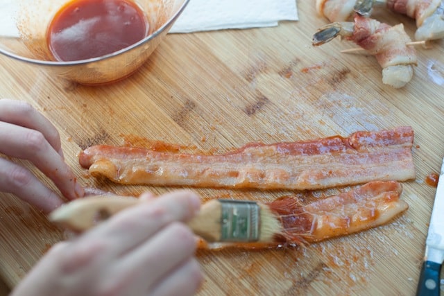 Brushing glaze onto the bacon