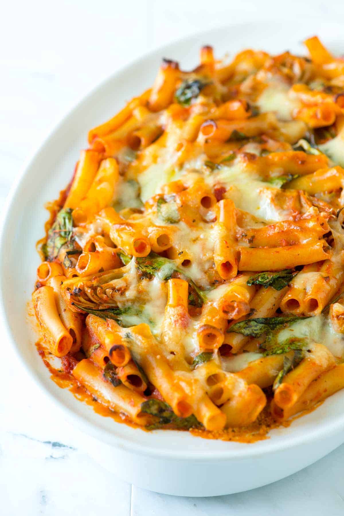 How to Make Seriously Good Baked Ziti with Spinach, Artichokes, and a Creamy Pesto Layer