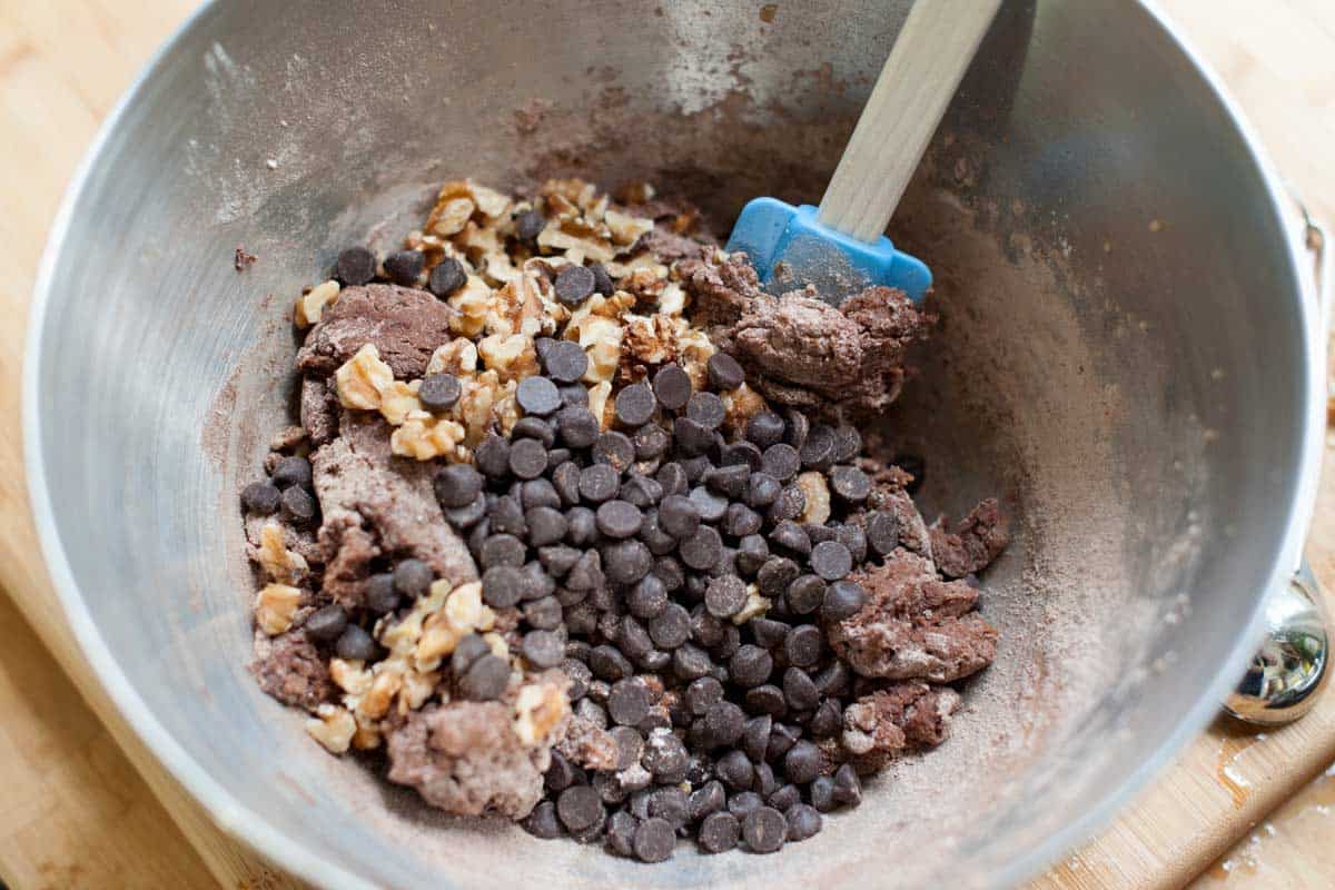 Making chocolate walnut cookie batter with chocolate chips