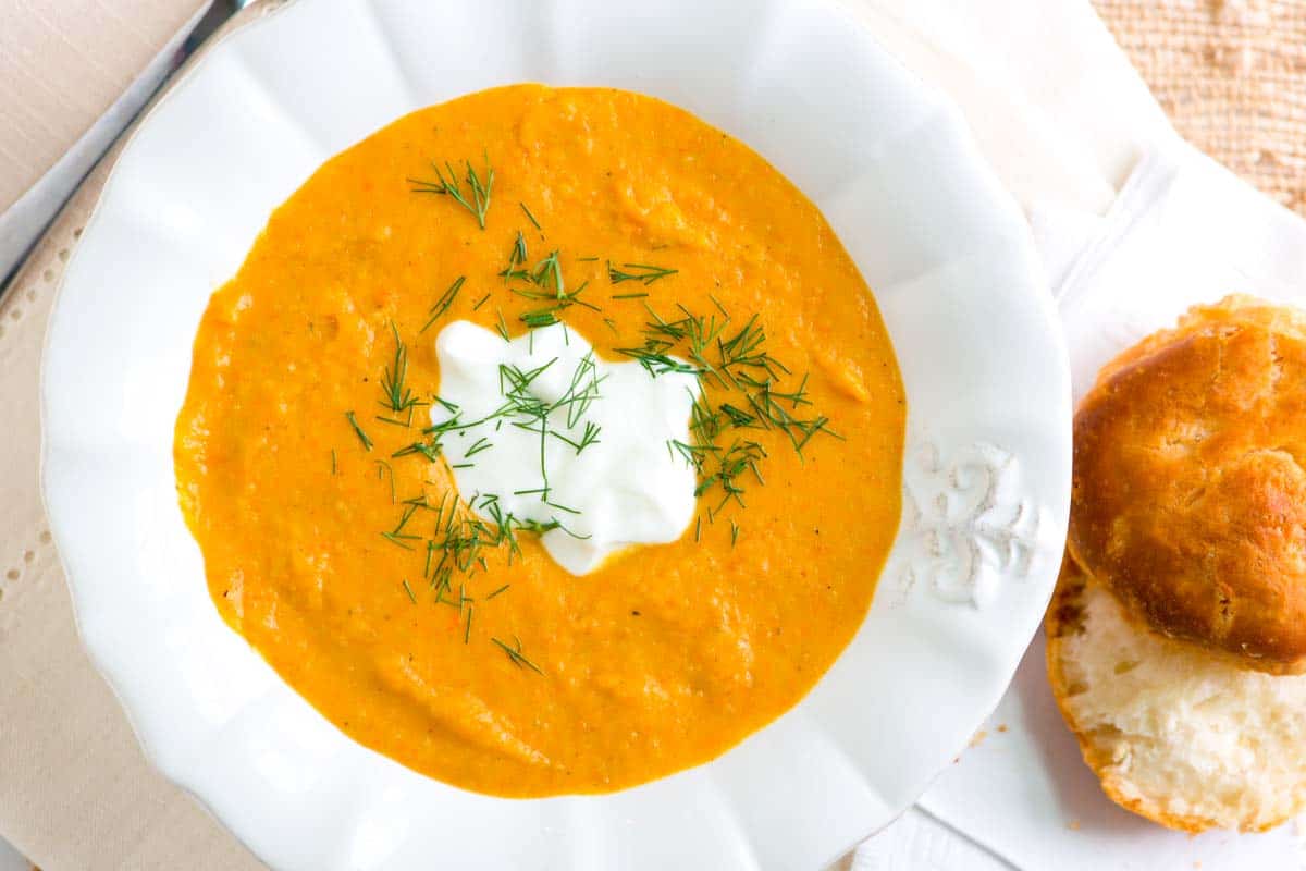 How to make curried coconut carrot soup with apple, potatoes and coconut milk. This simple soup is hearty, thick, and very satisfying!