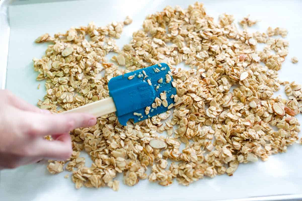 How to Make Homemade Granola Spreading oat mixture into one layer for granola