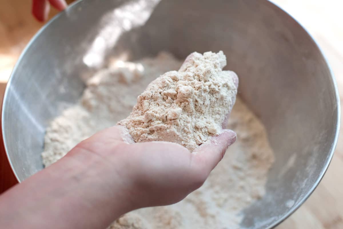 How to Make Pumpkin Scones: Cutting cold butter into flour.