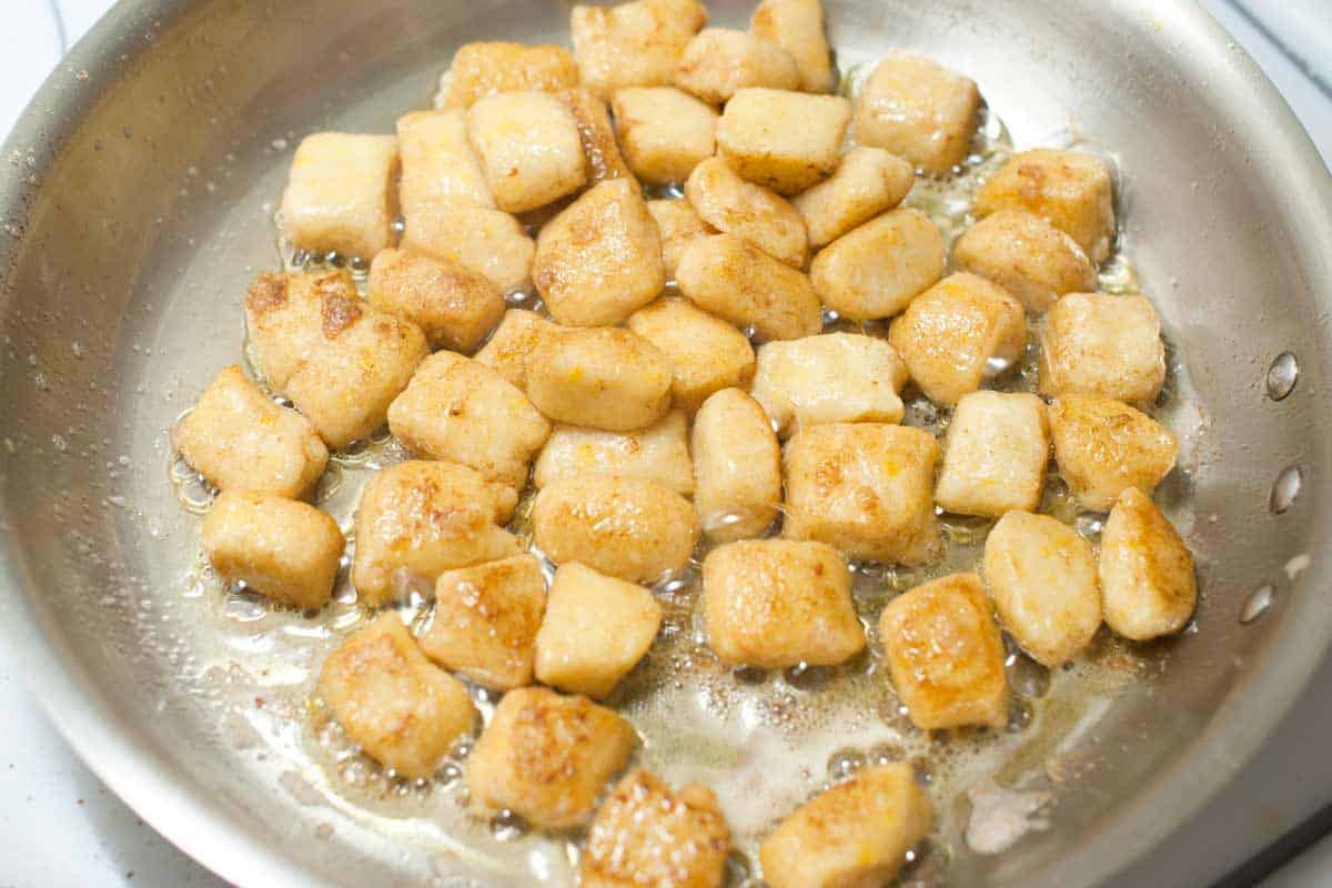 Gnocchi toasting in a skillet