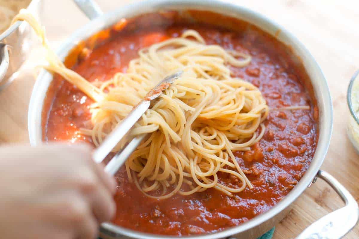 Toss spaghetti with marinara sauce