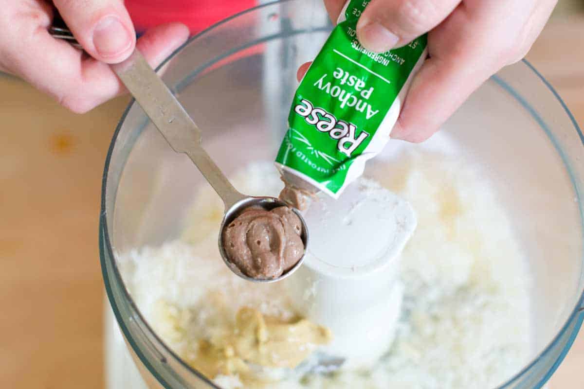 Easy Caesar Salad Dressing Recipe Adding anchovy paste to food processor to make the egg-free caesar dressing