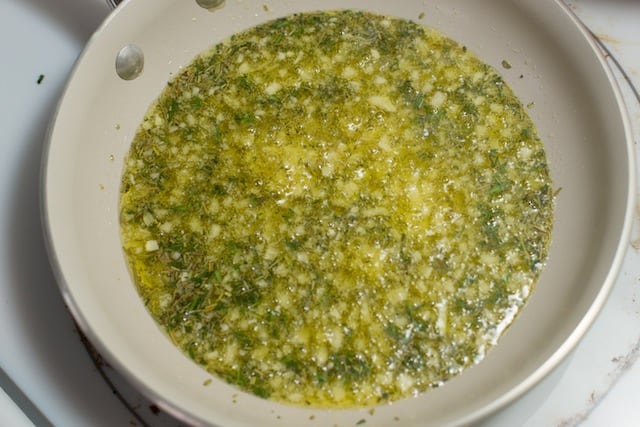 Infusing olive oil with garlic, rosemary, and thyme for focaccia.