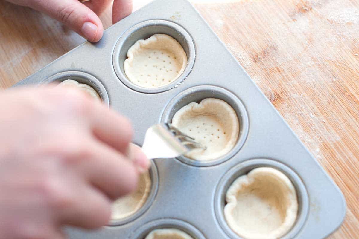 Easy Hummus Cups With Cucumber and Tomato How to Make Hummus Cups: Pressing pizza dough in to a muffin tin