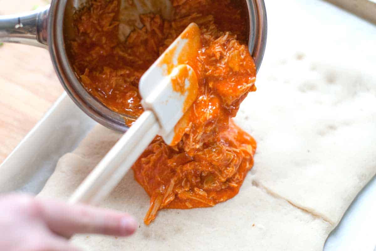 How to Make Crazy Good Buffalo Chicken Pizza Sticks Adding the buffalo chicken to the pizza