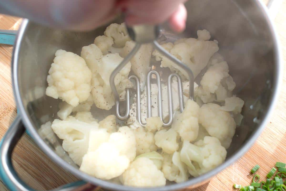 How to Make Mashed Cauliflower: Mashing cauliflower with potato masher