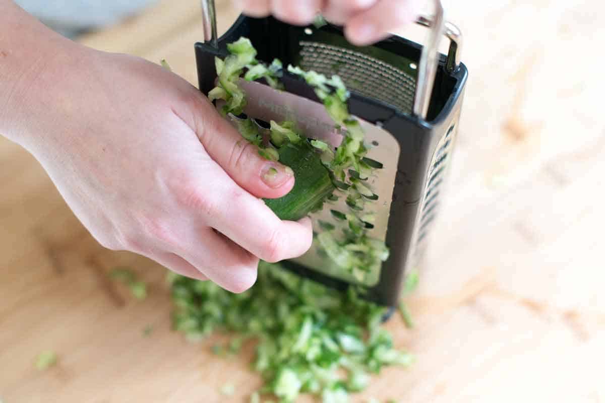 Grating cucumbers to help make the best tzatziki