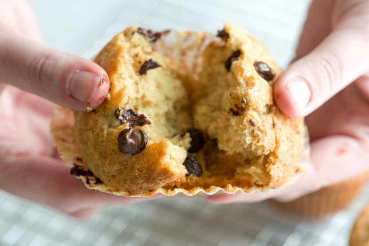 Breaking a chocolate chip muffin in half