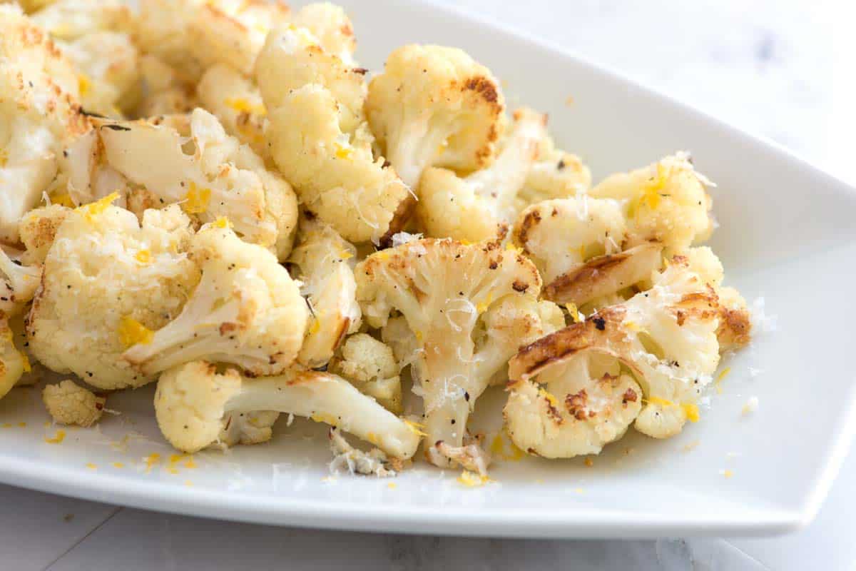 Parmesan Lemon roasted cauliflower is one of the tastiest ways to cook cauliflower! See how we turn boring cauliflower into perfectly tender and browned cauliflower.