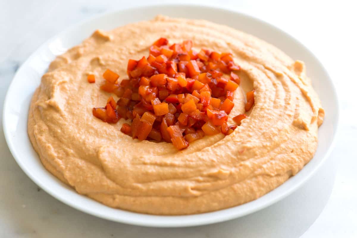 Easy red pepper hummus with sweet red bell peppers, chickpeas, garlic, and tahini.