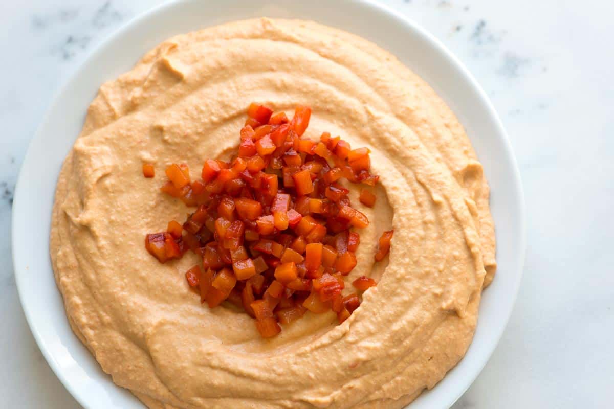 Easy red pepper hummus made with sweet red bell peppers, chickpeas, garlic, and tahini.