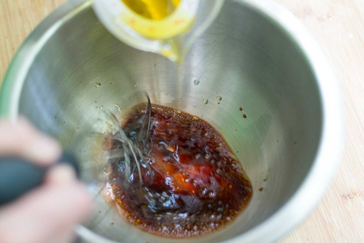 How to Make Homemade Balsamic Dressing Adding the oil slowly.