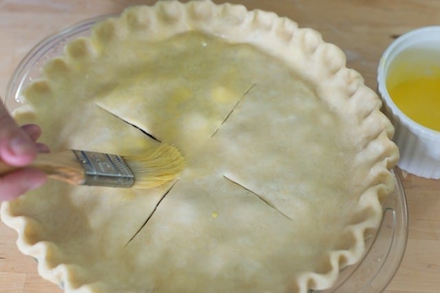 Adding the top crust to homemade cherry pie