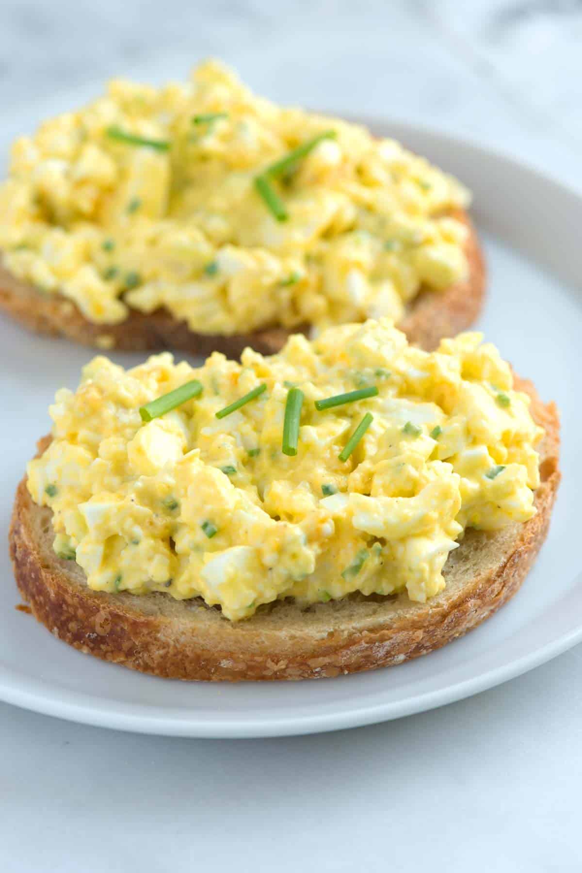 Open-faced egg salad sandwich on toasted bread