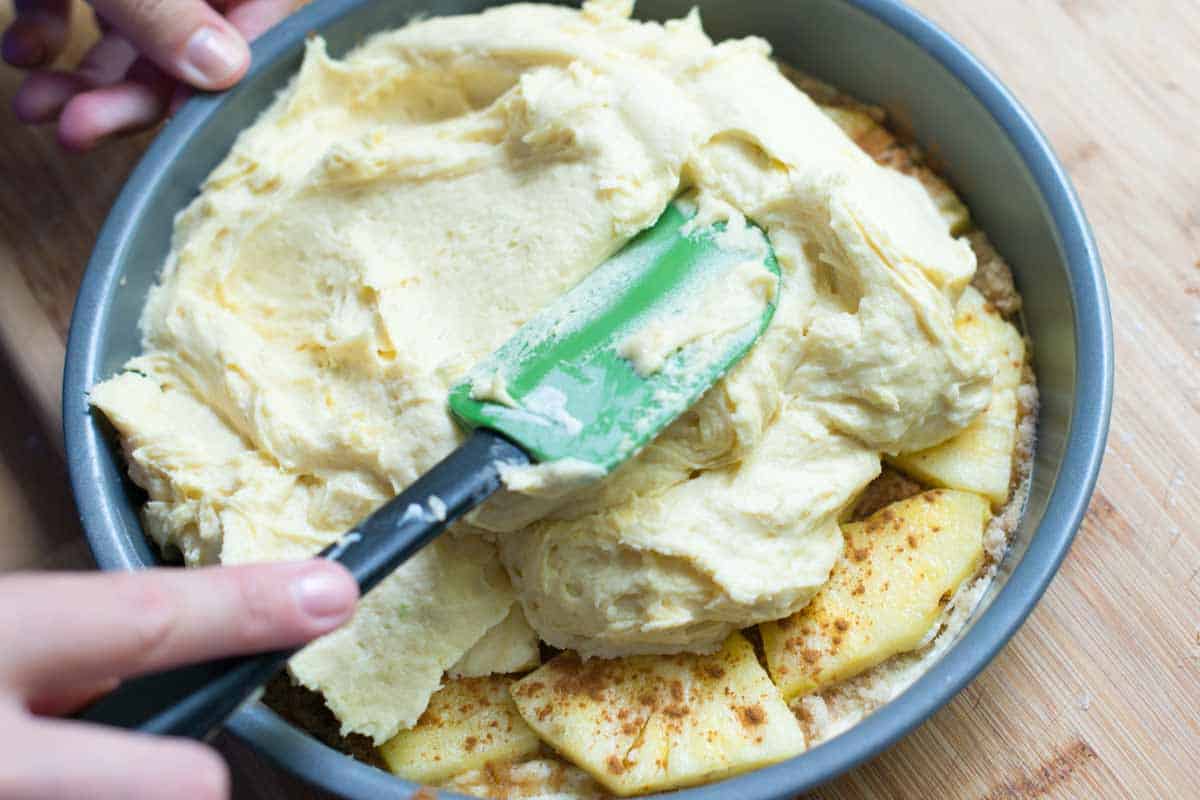 Use Fresh Pineapple for the Best Upside Down Pineapple Cake How to Make Pineapple Upside Down Cake - Spreading the cake batter over the pineapple.