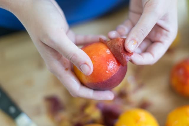 Peeling peaches for cobbler: Showing how easy the peel comes away after blanching peaches.