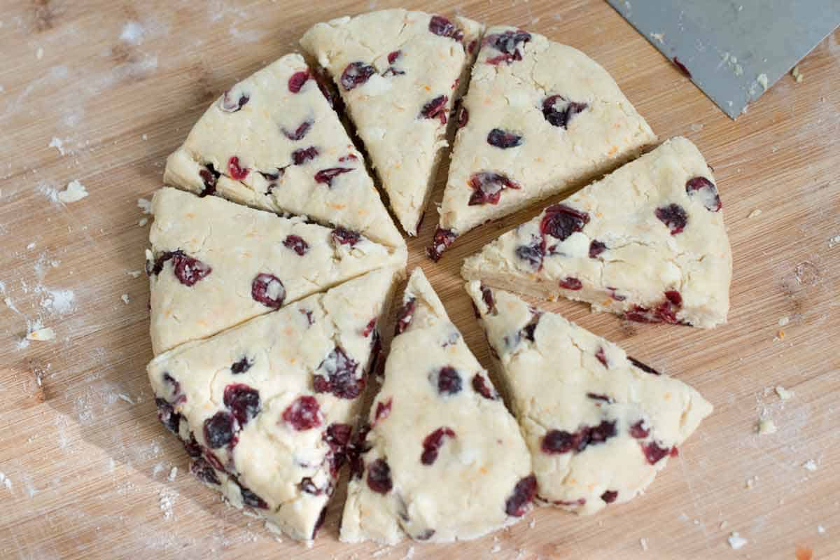 Cranberry Scones Recipe Cutting scone dough into triangles.