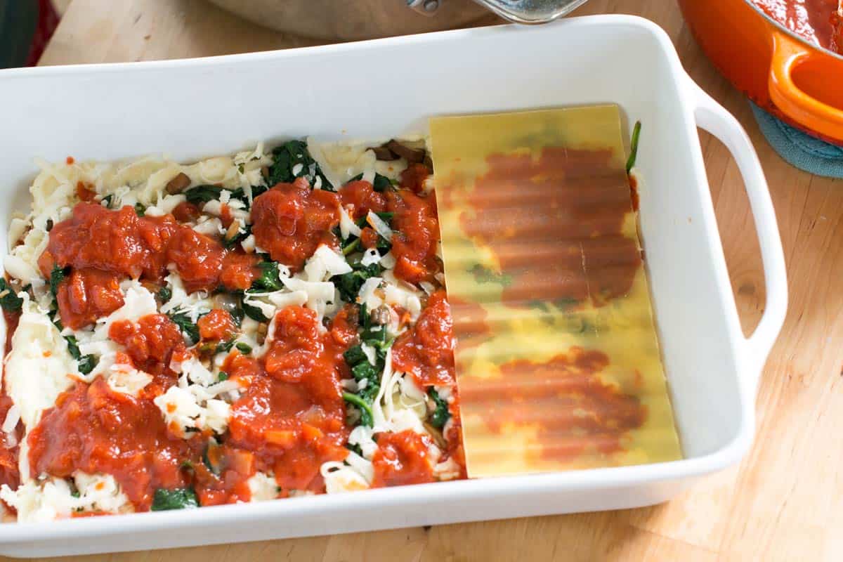 Assembling the spinach and mushroom lasagna