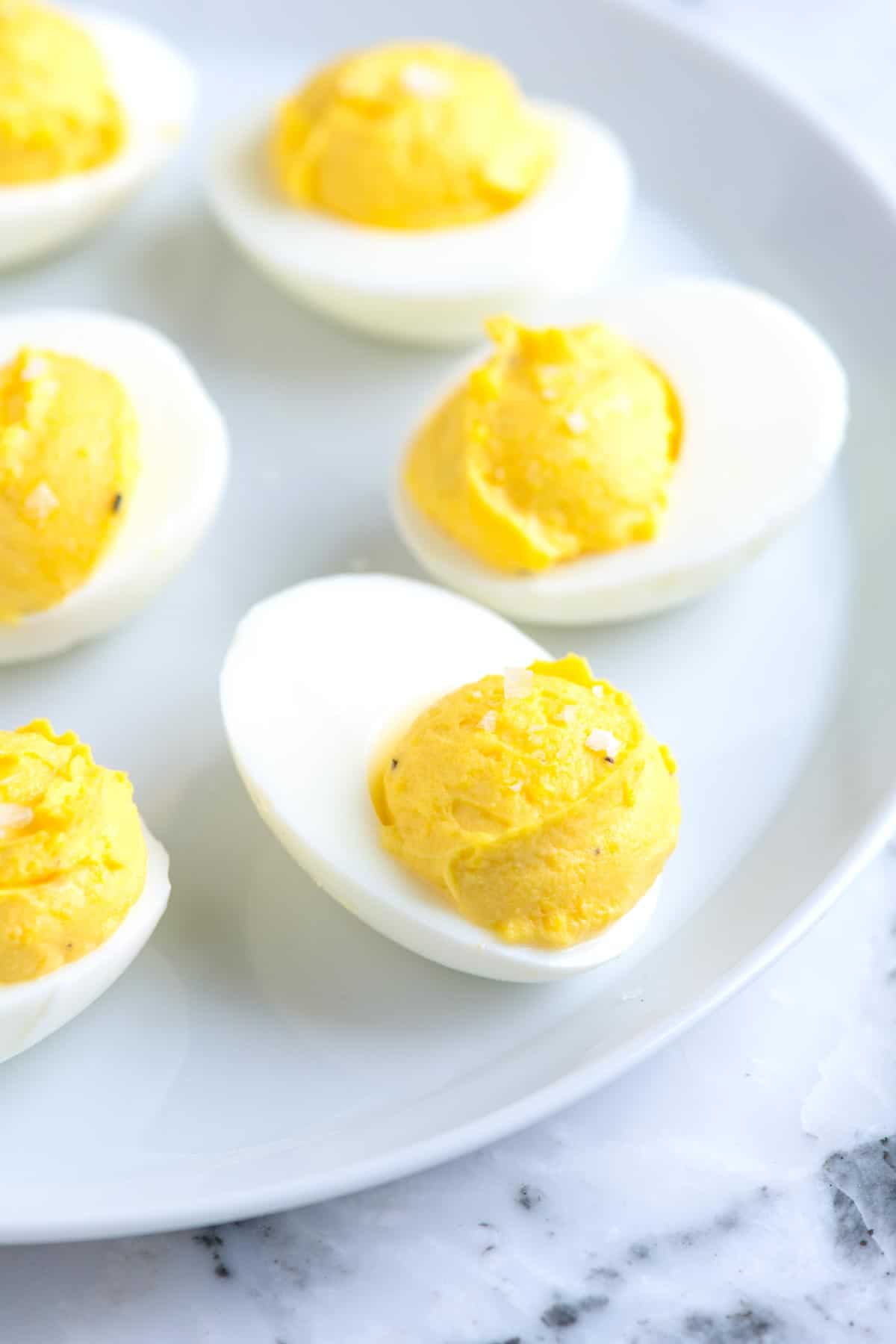 How to make the best deviled eggs with mayonnaise, vinegar, and mustard. Plus, suggestions for spicing them up and our best tips for hard boiling eggs.