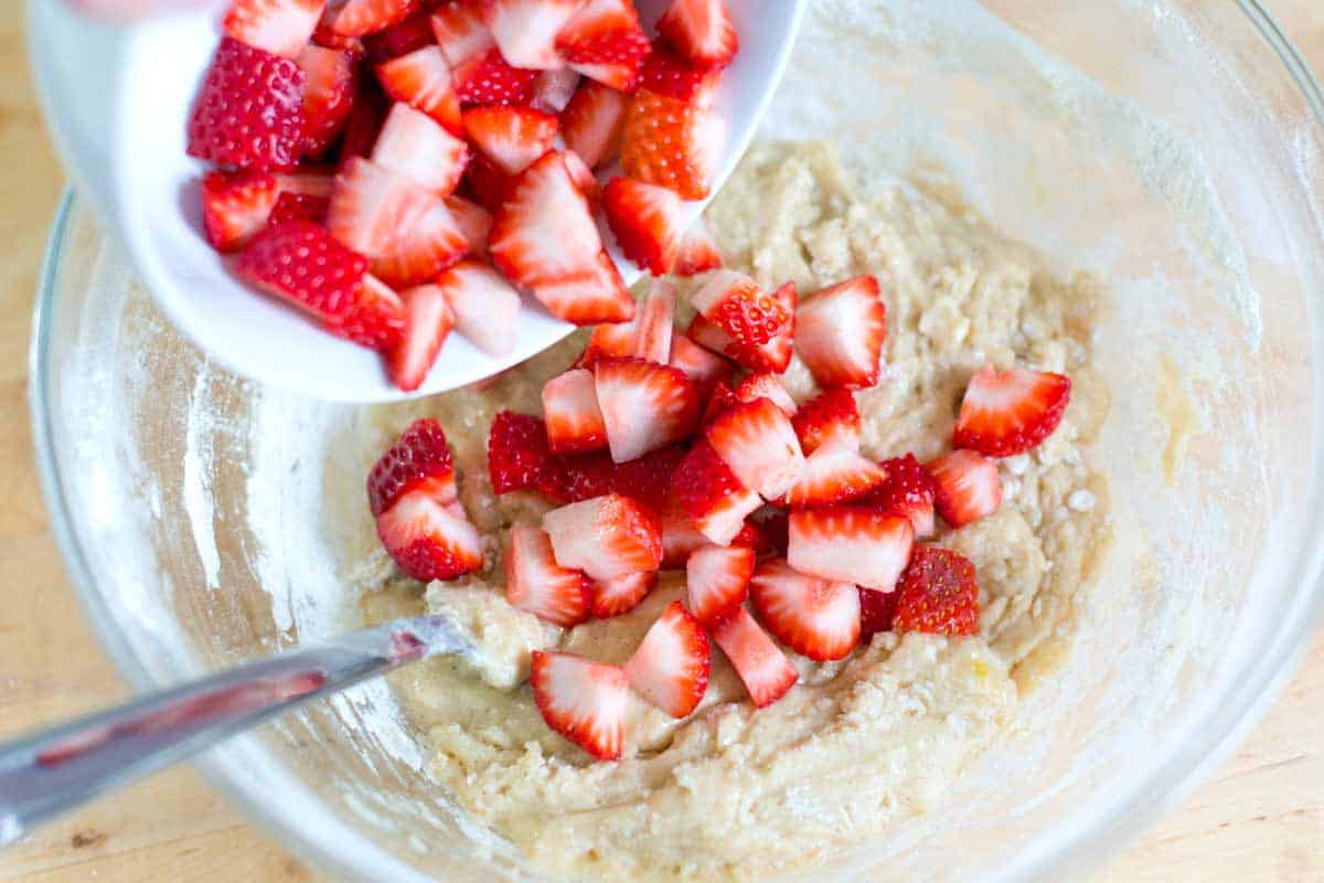 Adding the strawberries to muffin batter