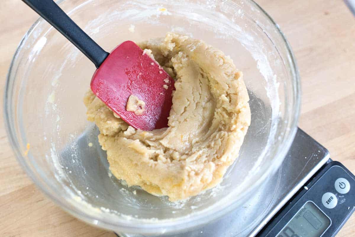 Adding flour and stirring the batter until a shiny, buttery dough forms.