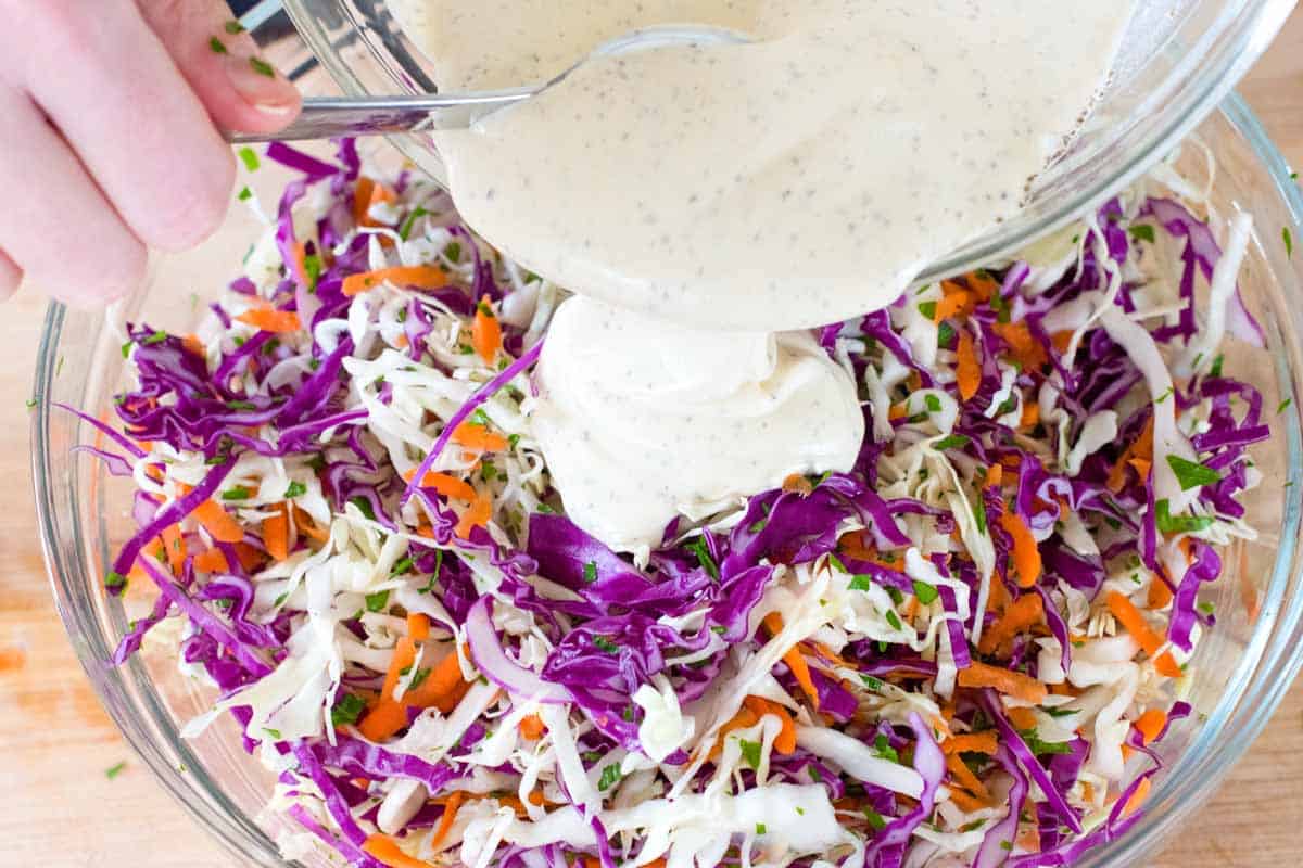 Adding coleslaw dressing to coleslaw ingredients