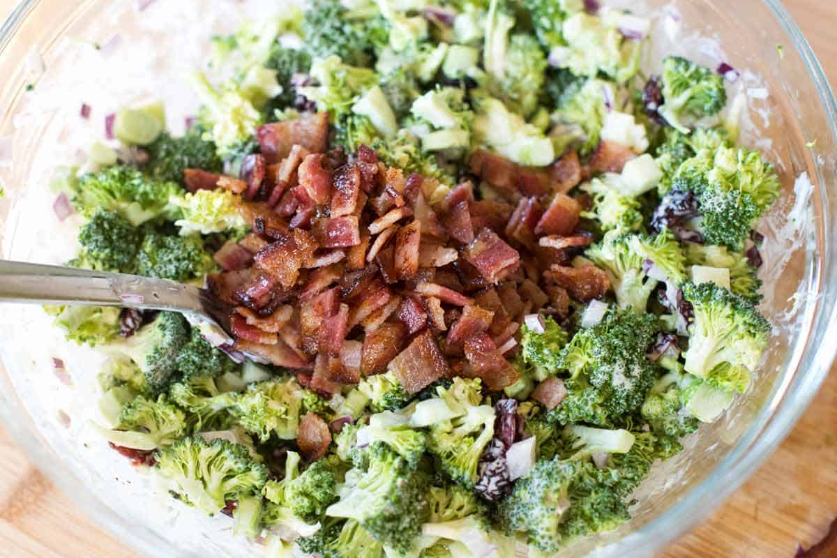 Adding bacon to the broccoli salad