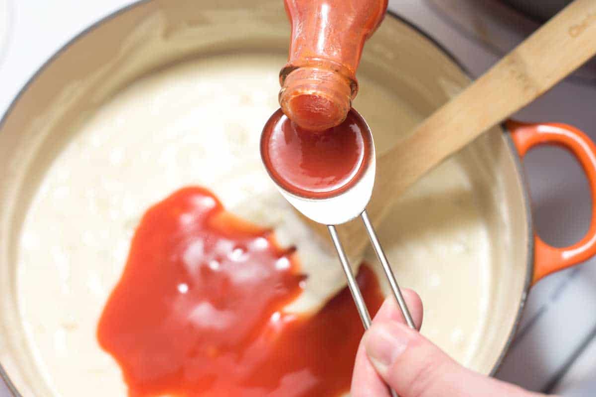 Adding the hot sauce
