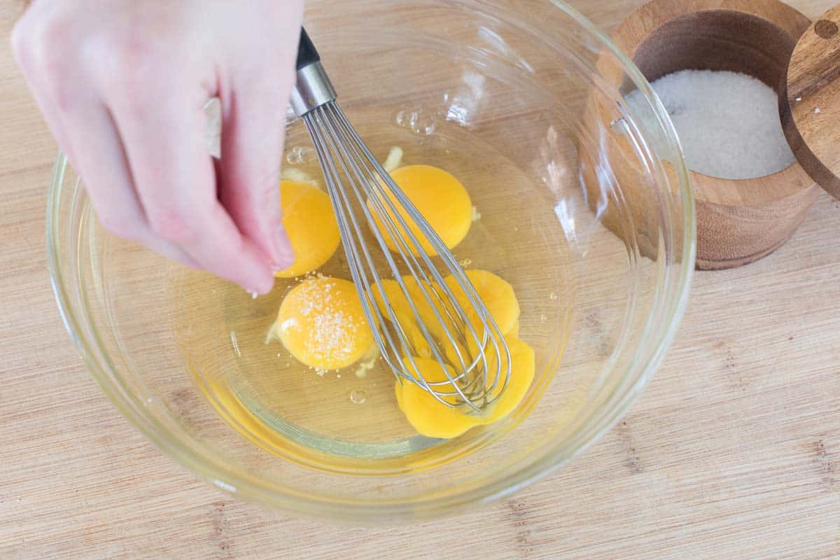 Whisking eggs with salt for scrambled eggs